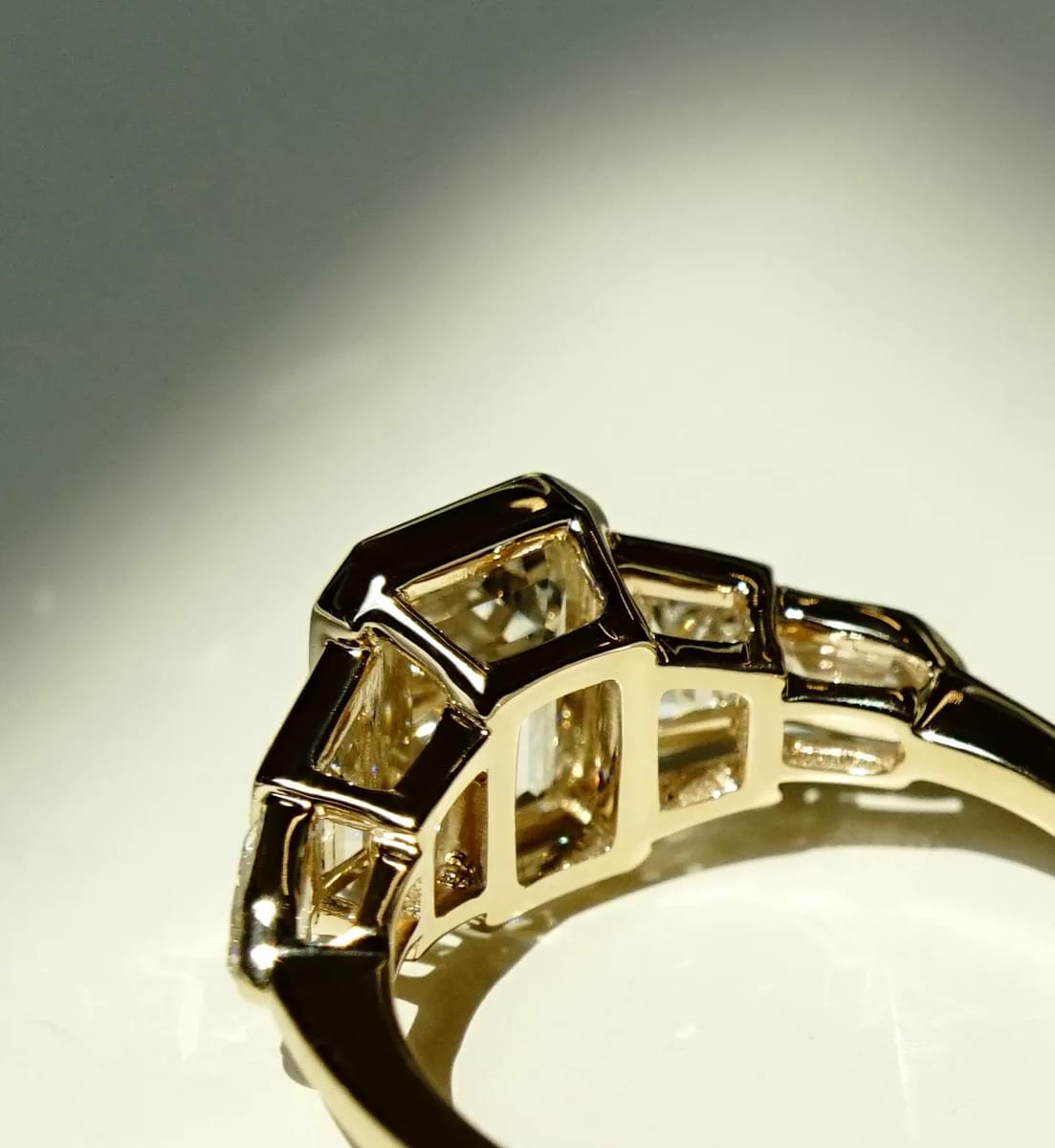 DSC09674-Medium | Frank Darling A closeup of the yellow gold shank of a five stone engagement ring.