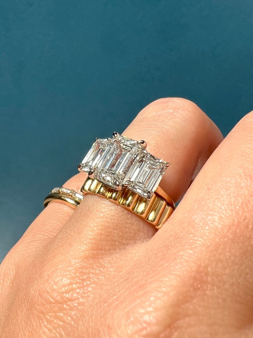IMG_3909-Large | Frank Darling Three ethical engagement rings including a three stone emerald cut stunner, our Lasagna bans, and a thin-stacking band